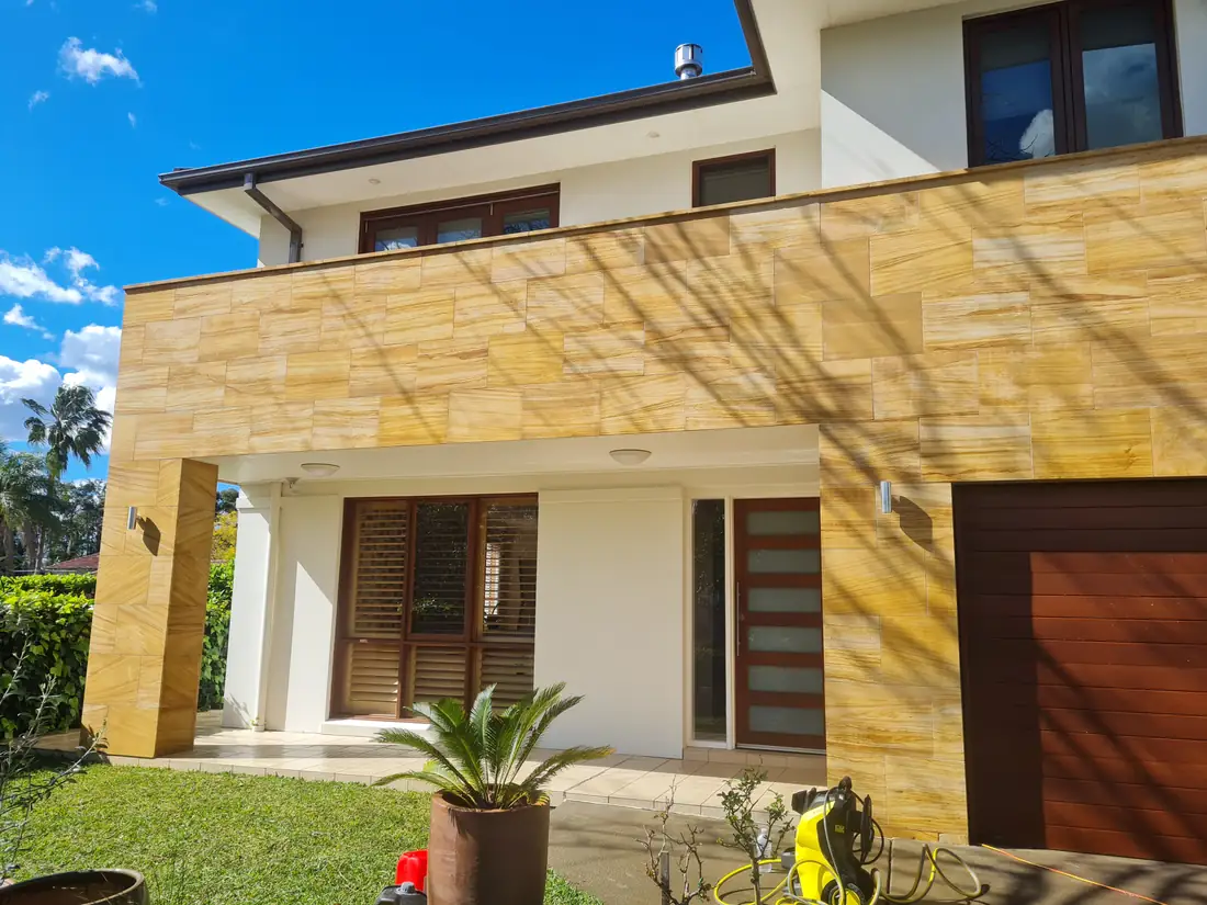 Contemporary two-storey home with a sandstone-clad façade